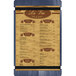 A white Menu Solutions wood menu board with blue and brown denim straps.