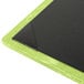 A Menu Solutions lime green and black wood menu board on a table.
