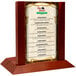 A mahogany wood menu holder with a 5" x 7" insert slot on a table.