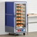 A blue Metro C5 heated holding and proofing cabinet with bread on the racks.