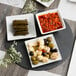 An Acopa round black slate tray with a plate of food on a table.