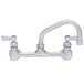 A Fisher stainless steel wall mount faucet with two lever handles.
