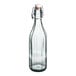 An Arcoroc clear glass bottle with a white cap.