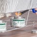 A can of Choice 4 Hour Wick Chafing Dish Fuel with a safety twist cap being lit with a lighter.