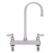 A stainless steel Fisher deck-mounted faucet with two lever handles and a gooseneck nozzle.