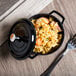 A black GET Heiss mini round bistro pot with rice and shrimp in it.