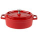 A red and white enamel coated oval pot with a lid.
