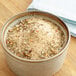 A bowl of Regal Upper Bay Crab Mix seasoning on a table.