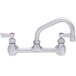 A Fisher stainless steel wall mount faucet with two lever handles and an 8" swing nozzle.