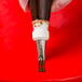 A hand using an Ateco 3-hole piping tip on a pastry bag filled with brown icing.