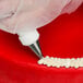 A close-up of an Ateco curved petal piping tip.