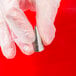 A hand in white gloves holding an Ateco open star piping tip.
