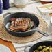 A steak cooking in a Valor cast iron grill pan.