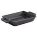 A black rectangular cast iron pan with handles.