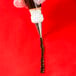 A person uses an Ateco closed star piping tip on a pastry bag with a liquid inside.