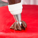 A person using an Ateco pastry bag with a Russian ball tip.