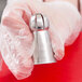 A person holding a silver metal Ateco Russian ball tip.