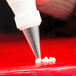 A pastry bag with an Ateco closed star tip on a table.