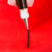 A hand holding a pastry bag with an Ateco open star tip.
