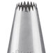 An Ateco silver metal drop flower piping tip with a small hole.