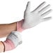 A person wearing Cordova cut resistant gloves with a gray palm.