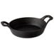 A black cast iron mini round casserole dish with handles.