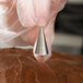 A person holding an Ateco Cross-Top Piping Tip.
