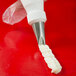 A pastry bag with the Ateco curved petal piping tip on it.