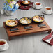 A table set with a Valor mini cast iron casserole dish filled with blueberries, a skillet of ice cream, and a cup of tea.