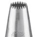 A silver metal Ateco Drop Flower piping tip with a small hole.