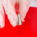 A hand holding an Ateco open star piping tip.