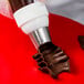 A person using an Ateco U-shape ruffle piping tip on a pastry bag.