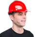 A man wearing a Cordova red cap style hard hat with a smile.