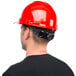 A man wearing a Cordova Duo Safety red cap style hard hat.