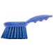 A blue Carlisle Sparta pot scrub brush with a handle and bristles.