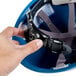 A hand holding a blue Cordova Duo Safety hard hat.