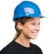 A woman wearing a Cordova blue hard hat.