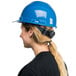 A woman wearing a Cordova blue hard hat with a ponytail.