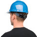 A man wearing a Cordova blue hard hat.