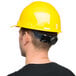 A man wearing a Cordova yellow hard hat.