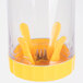A yellow and clear plastic container with yellow handles on a Weston corn stripper.