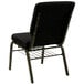 A Flash Furniture black church chair with a gold metal frame and dot patterned fabric.