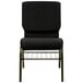 A black church chair with a gold metal frame and black dots.
