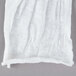 A pair of white Cordova cotton gloves on a gray surface.