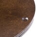 A close up of a Bon Chef mahogany lazy susan on a table.