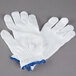 A pair of white Cordova work gloves with blue trim.