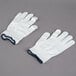 A pair of Cordova medium weight white nylon work gloves with a blue band.