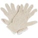 A pair of beige knitted gloves.