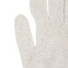 A close up of a Cordova medium weight natural polyester/cotton jersey glove with blue trim.