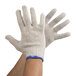 A person wearing white gloves.